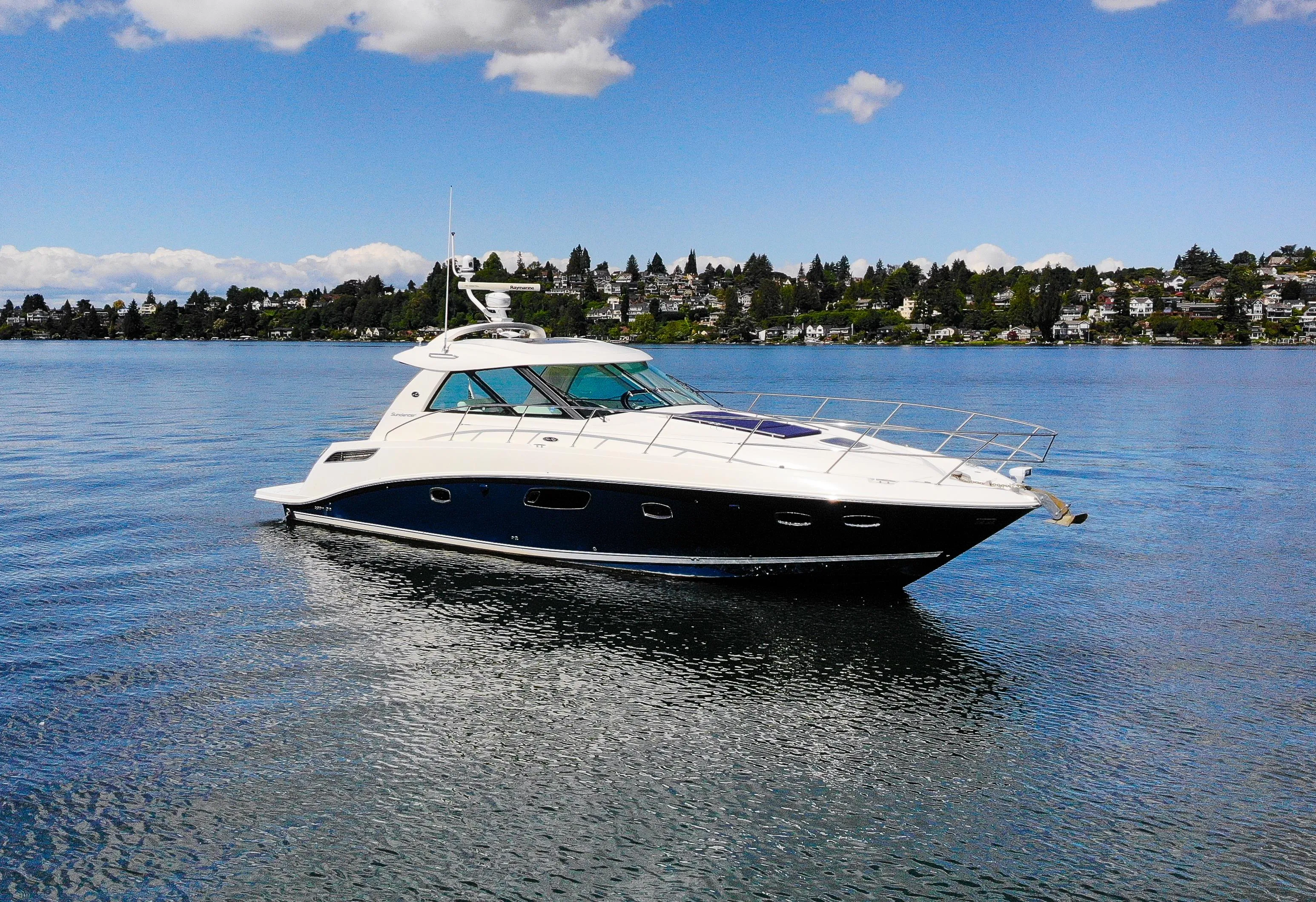 The 2011 Sea Ray 450 Sundancer under way with the Miami skyline behind it